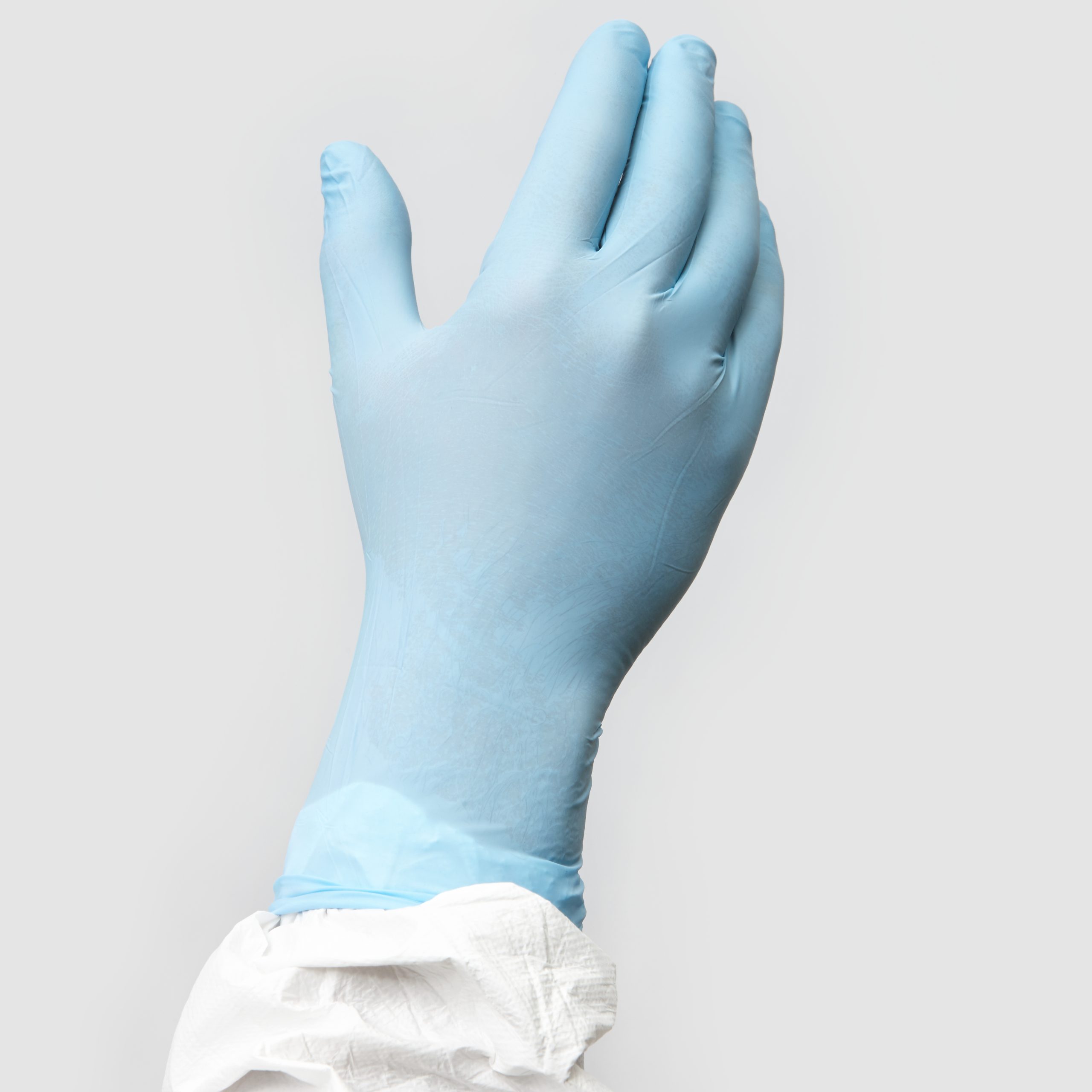 Hand die einen blauen Handschuh trägt