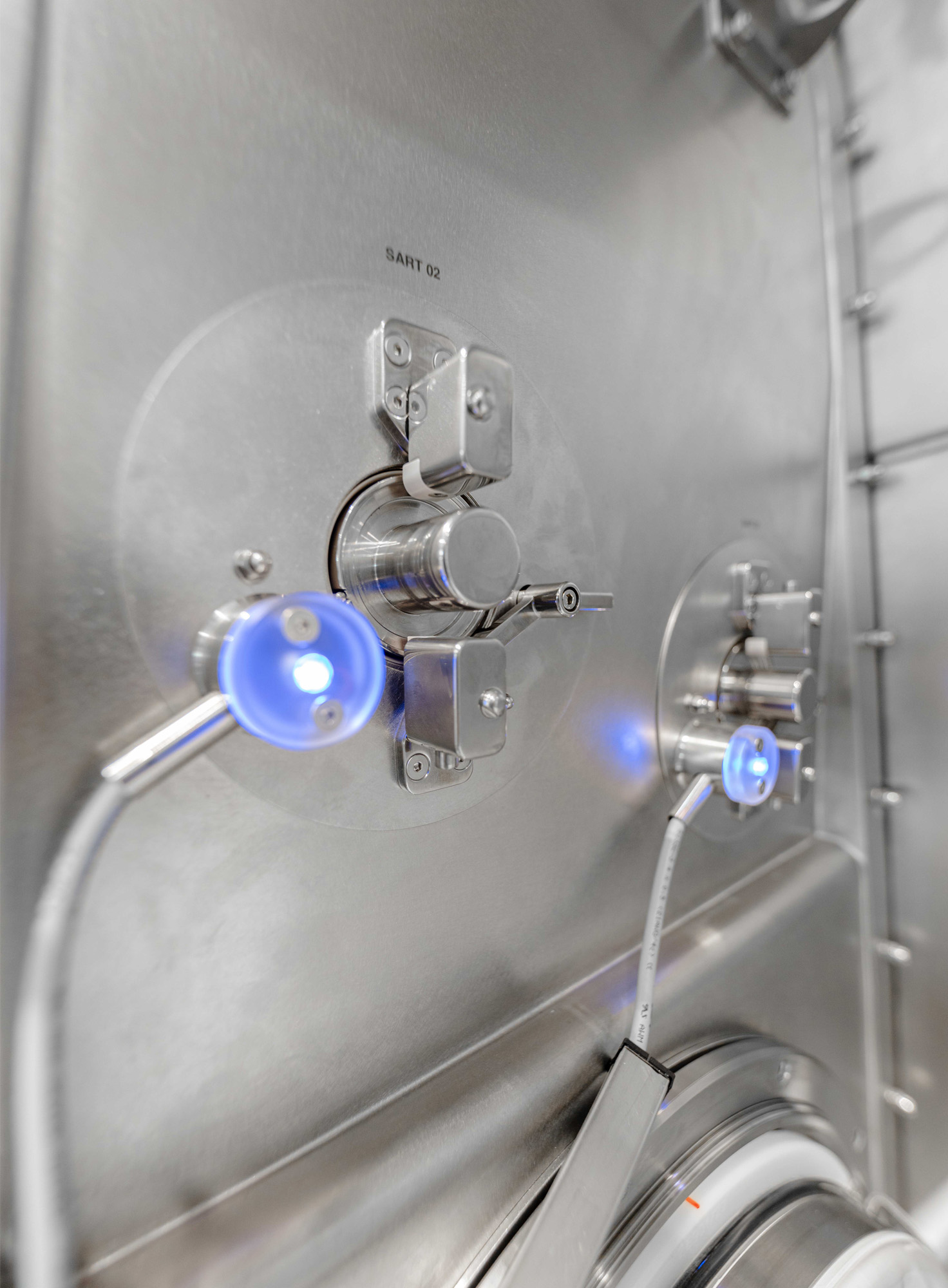 SART port system with blue indicator lights in isolator wall.