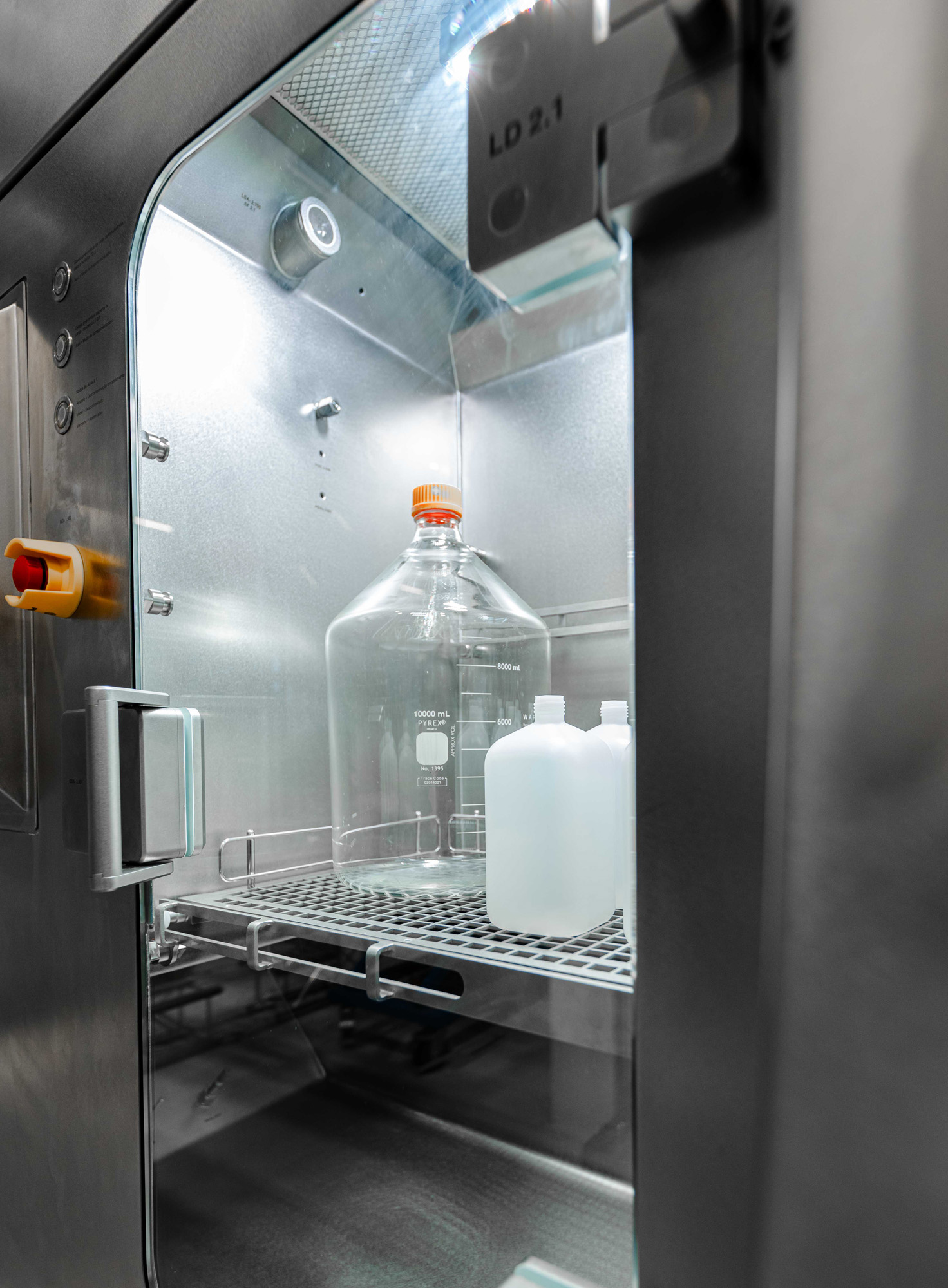 Bottles inside a stainless steel pass-through chamber.
