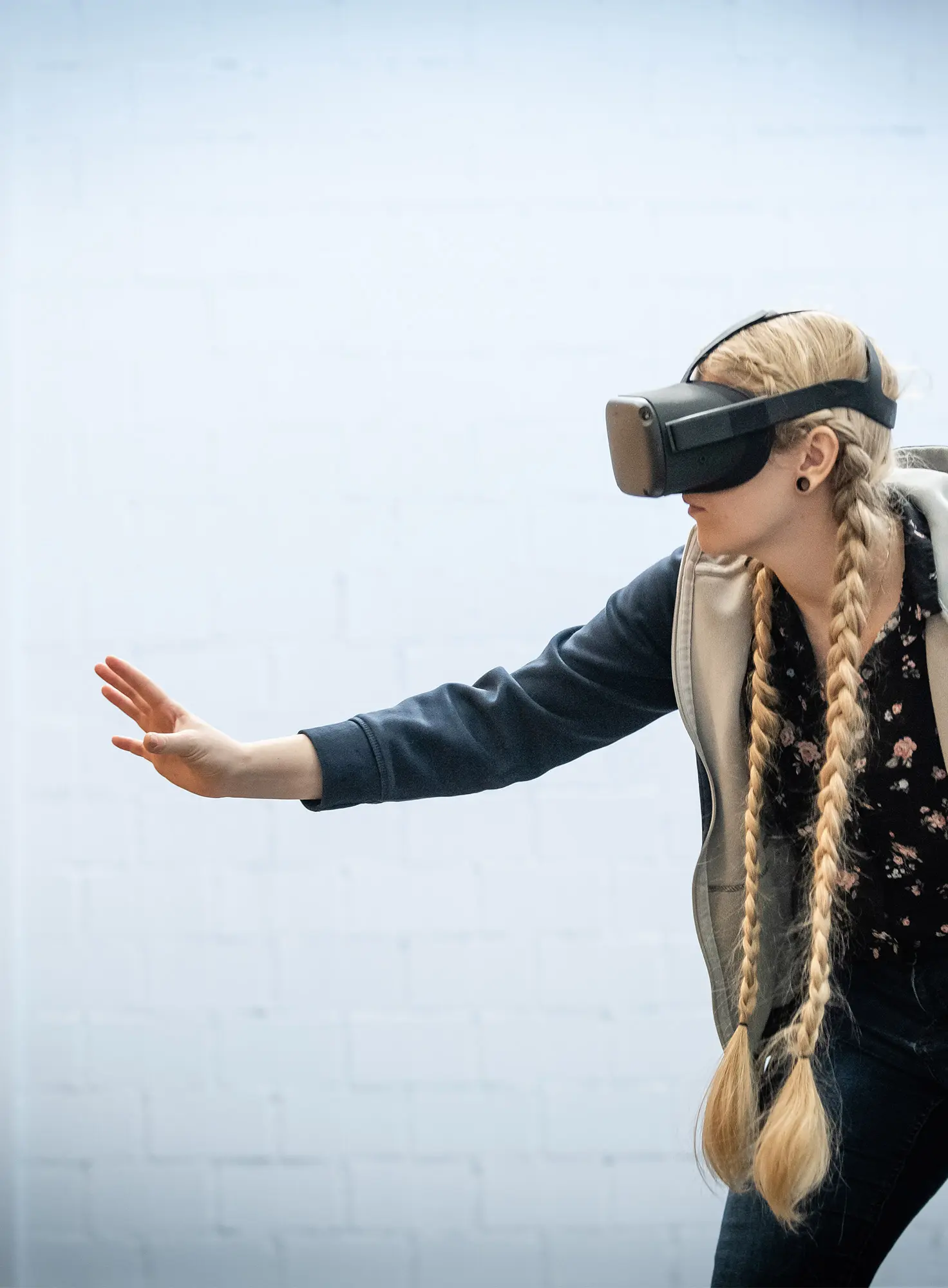 A woman with VR glasses moves slowly